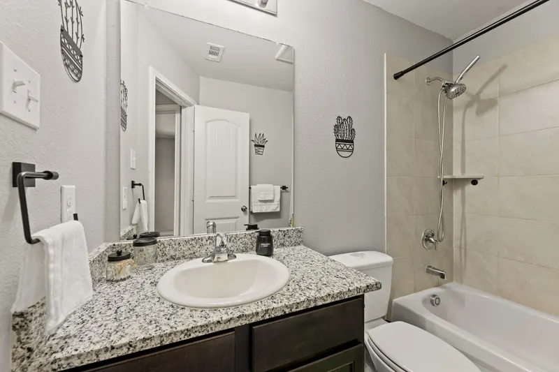 Hall bathroom vanity with granite counter