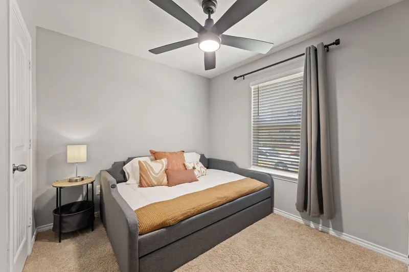 Second bedroom with a full trundle daybed and terracotta pillows