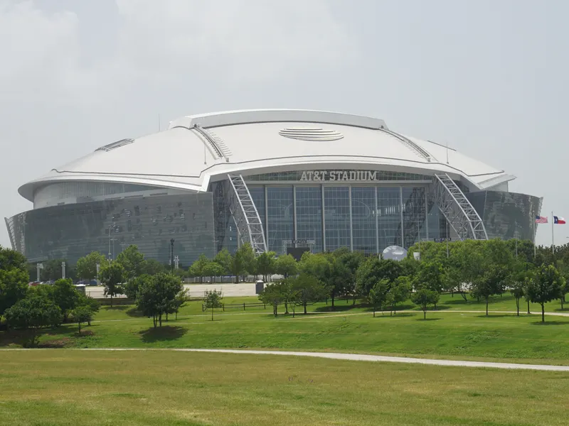 AT&T Stadium in Arlington seen across a green lawn