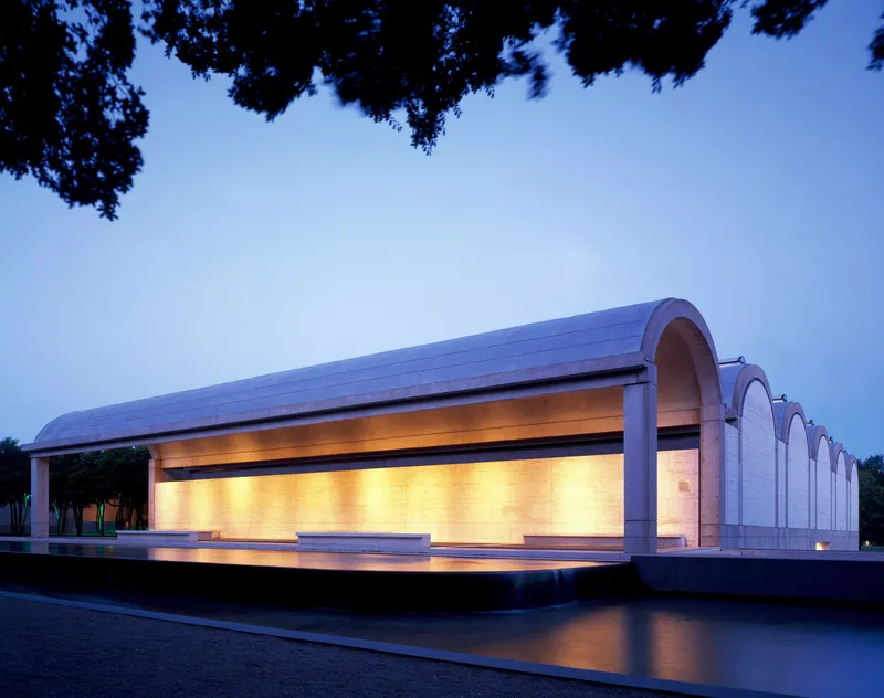 The Kimbell Art Museum's vaulted building glowing at dusk