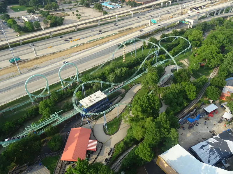 Aerial view of a roller coaster at Six Flags Over Texas beside the highway