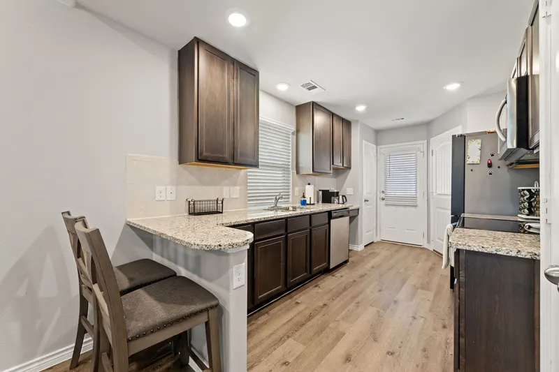 Breakfast bar with two stools beside the kitchen